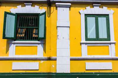 Low angle view of yellow windows on building