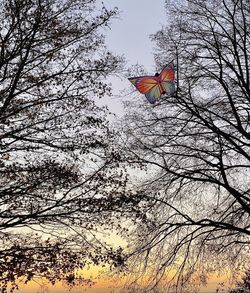 Low angle view of flags against clear sky during sunset