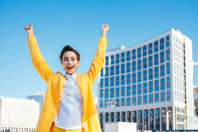 Rear view of woman standing against clear sky