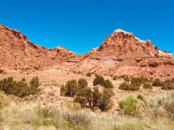 Scenic view of rocky mountains against clear blue sky