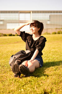 Young woman sitting on field