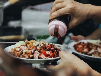 Close-up of cropped hand holding food