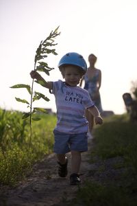 Rear view of boy standing on field
