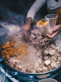Midsection of man preparing food
