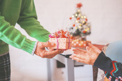 Midsection of woman holding christmas presents
