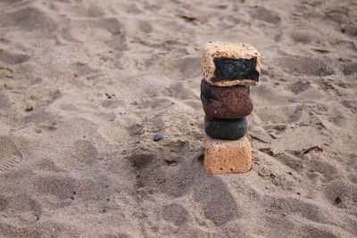 Close-up of stacked stack on sand