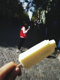 Cropped image of man holding ice cream