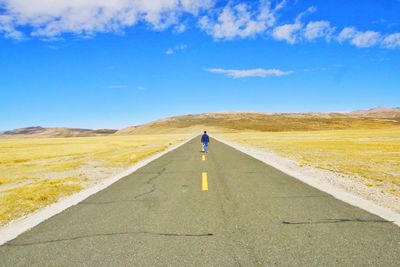 Man standing on road against sky