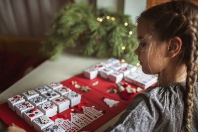 Close-up of girl looking at christmas tree