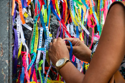 Catholics are seen tying colorful ribbons as souvenirs at the gate of the senhor do bonfim church