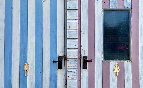 Gender colour specific wooden toilet doors.