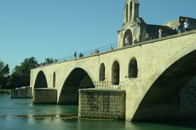 Bridge over river with buildings in background