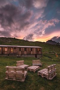 Built structure on field against sky during sunset
