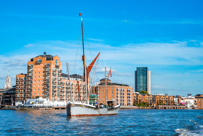 Boats and small ships docked on a river thames in london, uk.