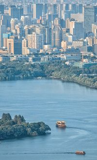 High angle view of buildings by sea