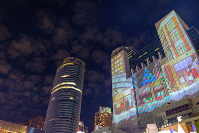 Low angle view of illuminated buildings against sky