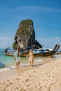 People on beach against sky