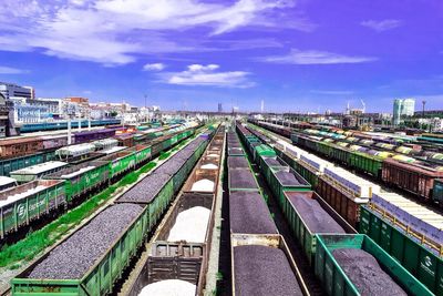 High angle view of freight trains at shunting yard against sky
