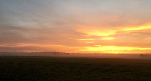 Scenic view of landscape against sky at sunset