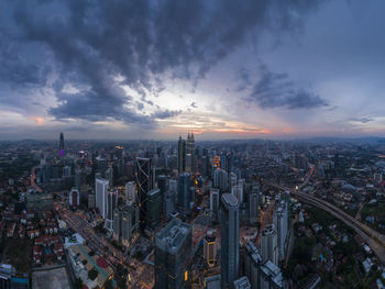 High angle view of modern buildings against sky during sunset