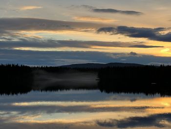 Scenic view of lake against orange sky
