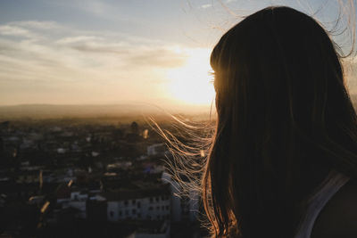 Rear view of woman at sunset