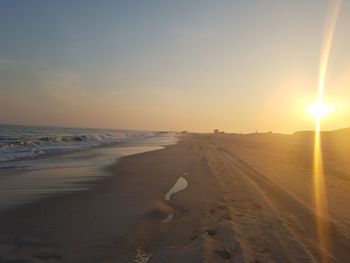 Scenic view of beach against sky during sunset