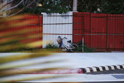 Bicycle parked against brick wall in city
