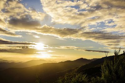 Scenic view of silhouette mountains against sky at sunset