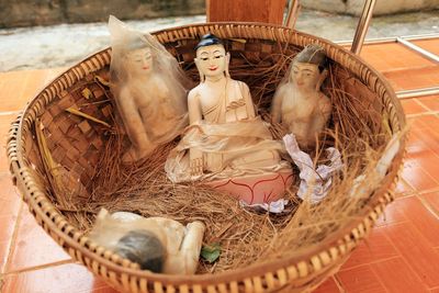 High angle view of buddha statue in basket