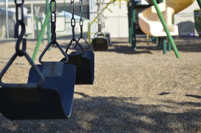 Empty swings hanging in row at playground