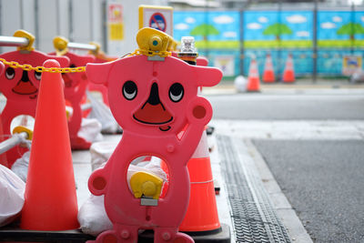 Red toys with traffic cones by road