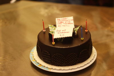 High angle view of birthday cake with message on table