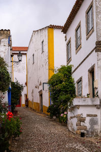 Street amidst buildings in town against sky