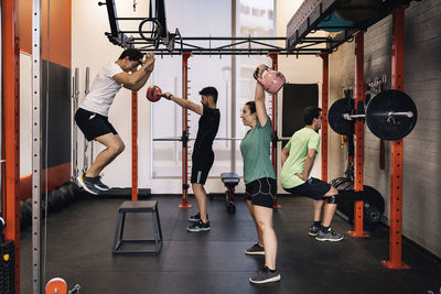 Group of beginners athletes exercising in a personal class with a private trainer. various exercises