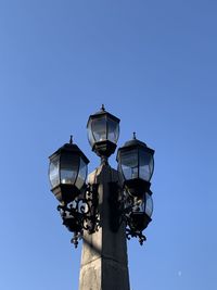 Low angle view of street light against clear blue sky