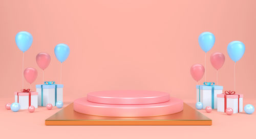 Multi colored balloons on table against wall at home