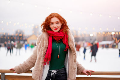 Portrait of smiling young woman standing outdoors