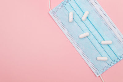 High angle view of colored pencils over pink background