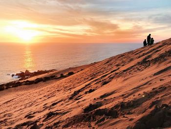 Scenic view of beach against sky during sunset