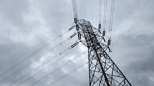 Low angle view of electricity pylon against sky