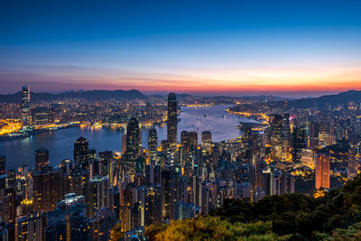 High angle view of city lit up at night