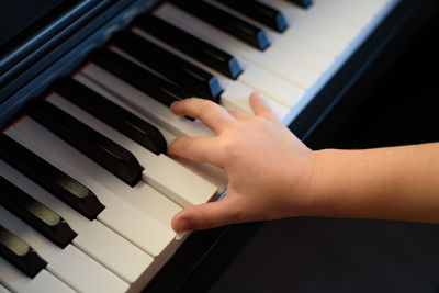 Midsection of man playing piano