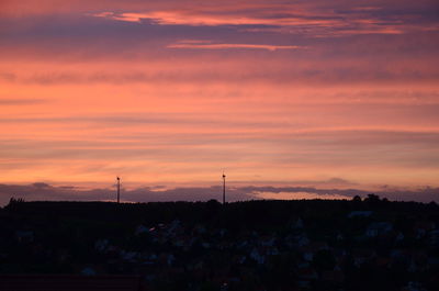 Scenic view of silhouette landscape against orange sky