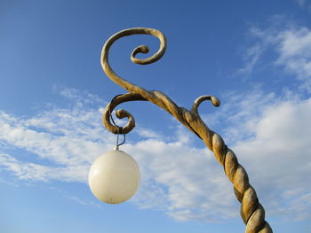 Low angle view of cross against sky