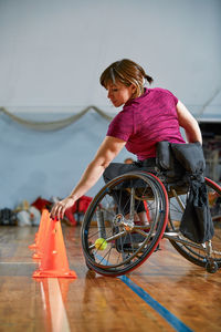 Portrait of young woman riding bicycle on floor