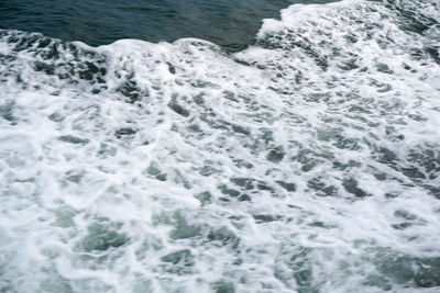 High angle view of waves splashing in sea