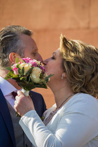 Close-up of mature couple kissing outdoors
