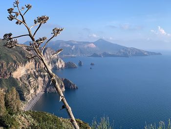 Scenic view of sea and mountains against sky