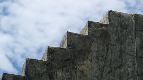 Low angle view of building against cloudy sky